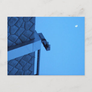 The moon hangs above the breakwater. postcard