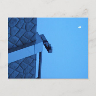 The moon hangs above the breakwater. postcard