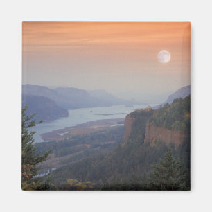 The moon hangs in the sky above the Vista Magnet