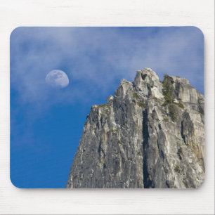 The moon rises and shines through the clouds mouse pad