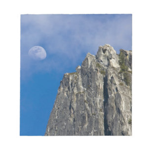 The moon rises and shines through the clouds notepad