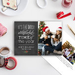 The Most Wonderful Time Rustic Chalkboard Photo Holiday Card<br><div class="desc">Holiday photo card design features a vintage rustic style with "It's the most wonderful time of the year" mixed typography,  an accent of Christmas greenery,  and a black chalkboard background with a textured appearance.</div>