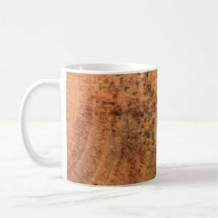 The mould that grows on the brown wood surface is coffee mug