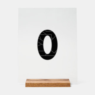 The number zero (0) in black acrylic sign