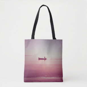 The silhouette of fisherman with boat in the sea v tote bag