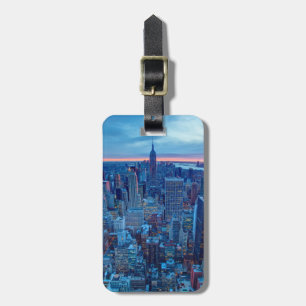 The skyscrapers of Manhattan are lit Luggage Tag