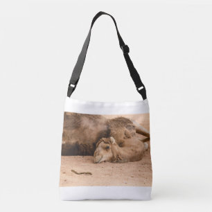 the sleepy look of a dromedary on crossbody bag