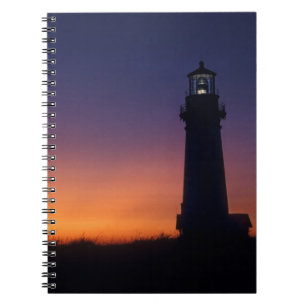 The sun ball drops down on the colourful horizon notebook
