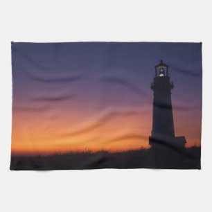 The sun ball drops down on the colourful horizon tea towel