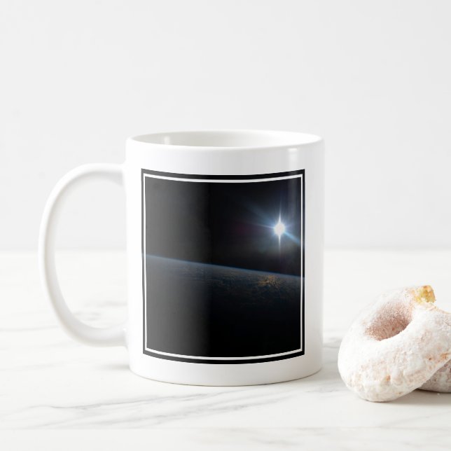 The Sun Setting Over Earth's Horizon. Coffee Mug (With Donut)