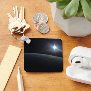 The Sun Setting Over Earth's Horizon. Key Ring