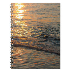 The sunset reflection on the beautiful ocean water notebook