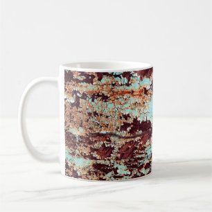The texture of a rusty iron and a blue strongly pe coffee mug