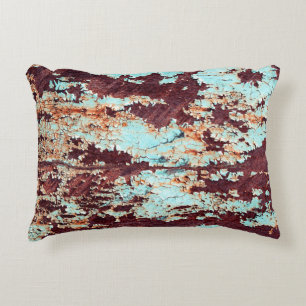 The texture of a rusty iron and a blue strongly pe decorative cushion