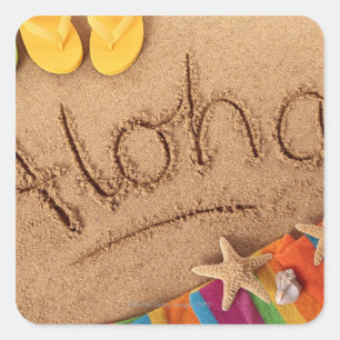 The word Aloha written on a sandy beach, with 2 Square Sticker