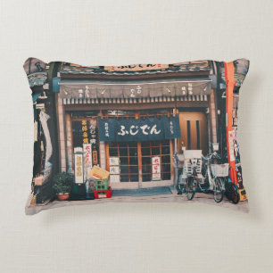 THREE BICYCLES PARKED IN FRONT OF BUILDING DECORATIVE CUSHION