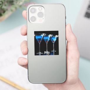 Three blue cocktails with cherry on black