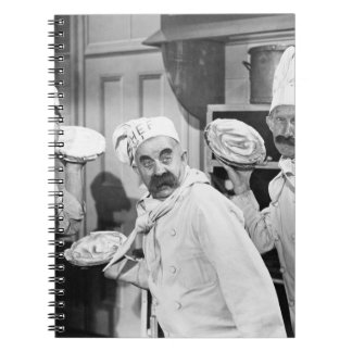 Three chefs holding pies for a fight in the kitche notebook