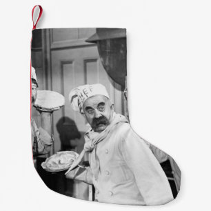 Three chefs holding pies for a fight in the kitche small christmas stocking