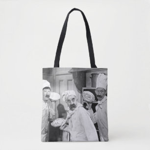 Three chefs holding pies for a fight in the kitche tote bag