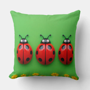 Three Colourful Ladybugs on Green Background Cushion