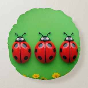 Three Colourful Ladybugs on Green Background Round Cushion