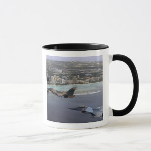 Three F-16 Fighting Falcons fly in formation Mug