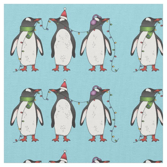 Three Festive Christmas Penguins On Light Blue Fabric (Close Up)
