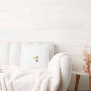 three flowers with green and orange petals cushion