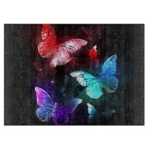 Three Glowing Butterflies on night background Cutting Board