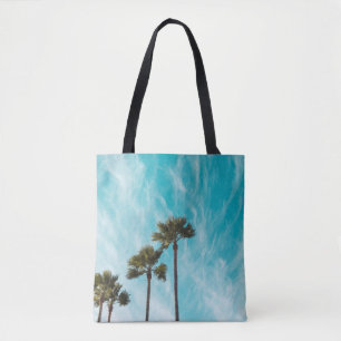 Three green leaf trees below cirus clouds tote bag