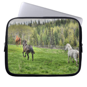 Three Horses Running on Fresh Grass in a Paddock Laptop Sleeve