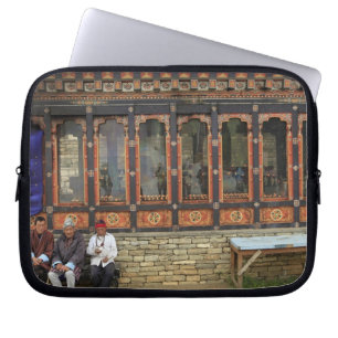 Three men sit on a bench at the Memorial Chorten Laptop Sleeve