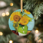Three Sunflowers | Vincent van Gogh Ceramic Ornament<br><div class="desc">Three Sunflowers (1888) by Vincent van Gogh is a vibrant still life that showcases the artist’s signature thick brushstrokes and bold use of colour. The painting features three sunflowers in a simple vase, their golden petals contrasting against the aqua blue background. Van Gogh's vivid yellow palette brings energy and life...</div>