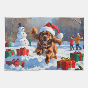 Tibetan Spaniel Running in Snow with Christmas Hat Tea Towel