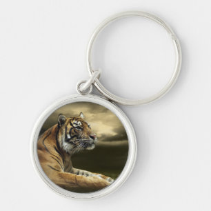 Tiger looking and sitting under dramatic sky key ring