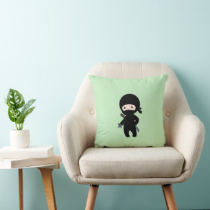 Tiny Ninja Holding Throwing Star On Green Cushion