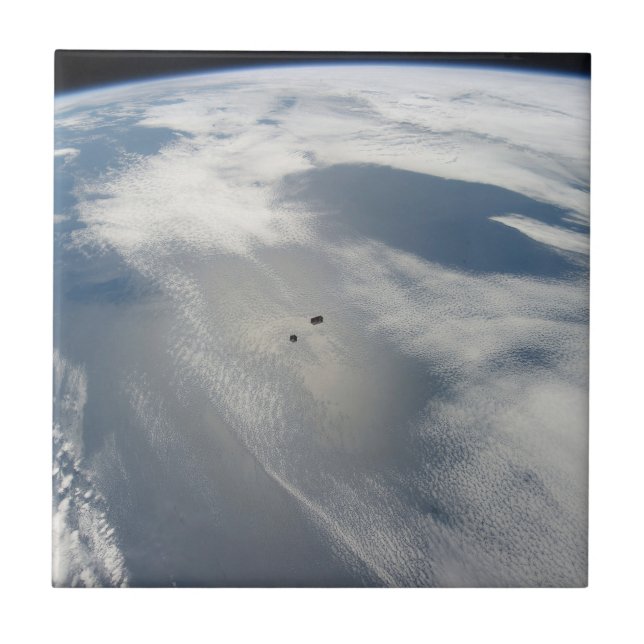 Tiny Satellites Orbit Above A Part Of Earth. Ceramic Tile (Front)