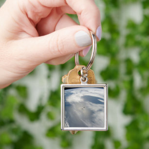 Tiny Satellites Orbit Above A Part Of Earth. Key Ring
