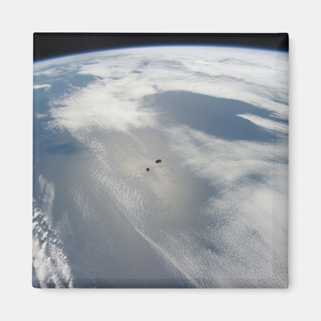 Tiny Satellites Orbit Above A Part Of Earth. Magnet (Front)