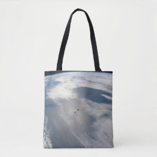 Tiny Satellites Orbit Above A Part Of Earth. Tote Bag