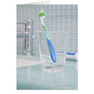 Toothbrush in a cup in the bathroom