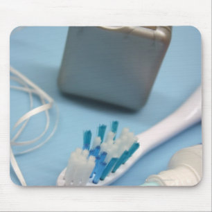 Toothbrush, toothpaste and floss. mouse pad