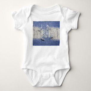 Torn blue denim: jeans texture. baby bodysuit