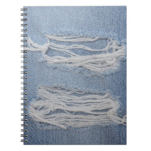 Torn denim: blue jeans texture. notebook