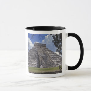 Tourists walk past an unrestored side of El 2 Mug