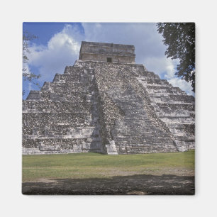 Tourists walk past an unrestored side of El Magnet
