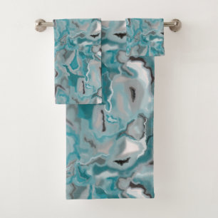 Towel with a turquoise grey abstract pattern.