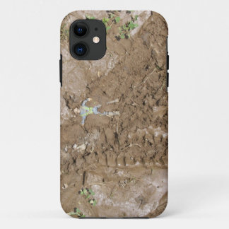 Toy man pushed into mud. iPhone 11 case