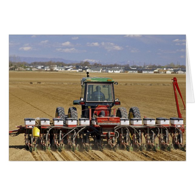 Tractor pulling a seed corn planter. (Front Horizontal)